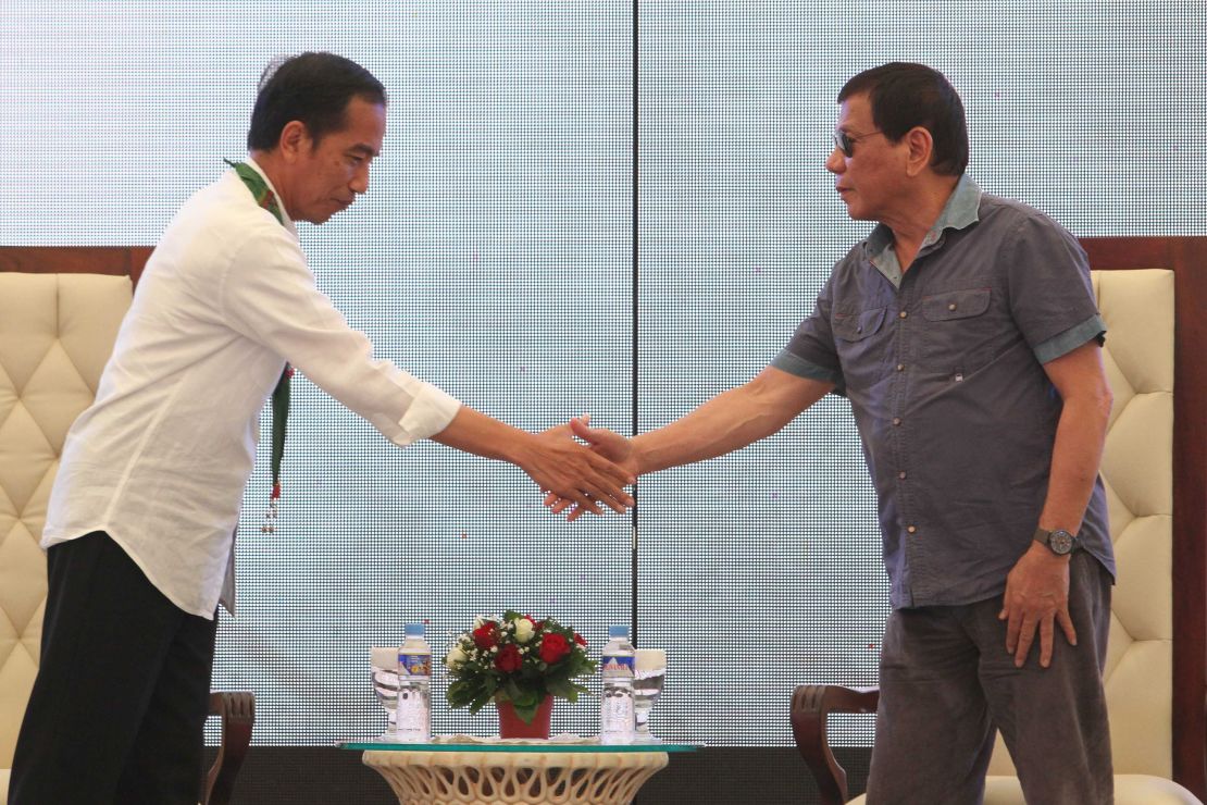 Indonesian President Joko Widodo (L) and President Rodrigo Duterte (R) shake hands in Mindanao, Philippines, on April 30.