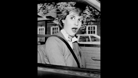 Diana looks startled after stalling her new car outside her London apartment in November 1980.