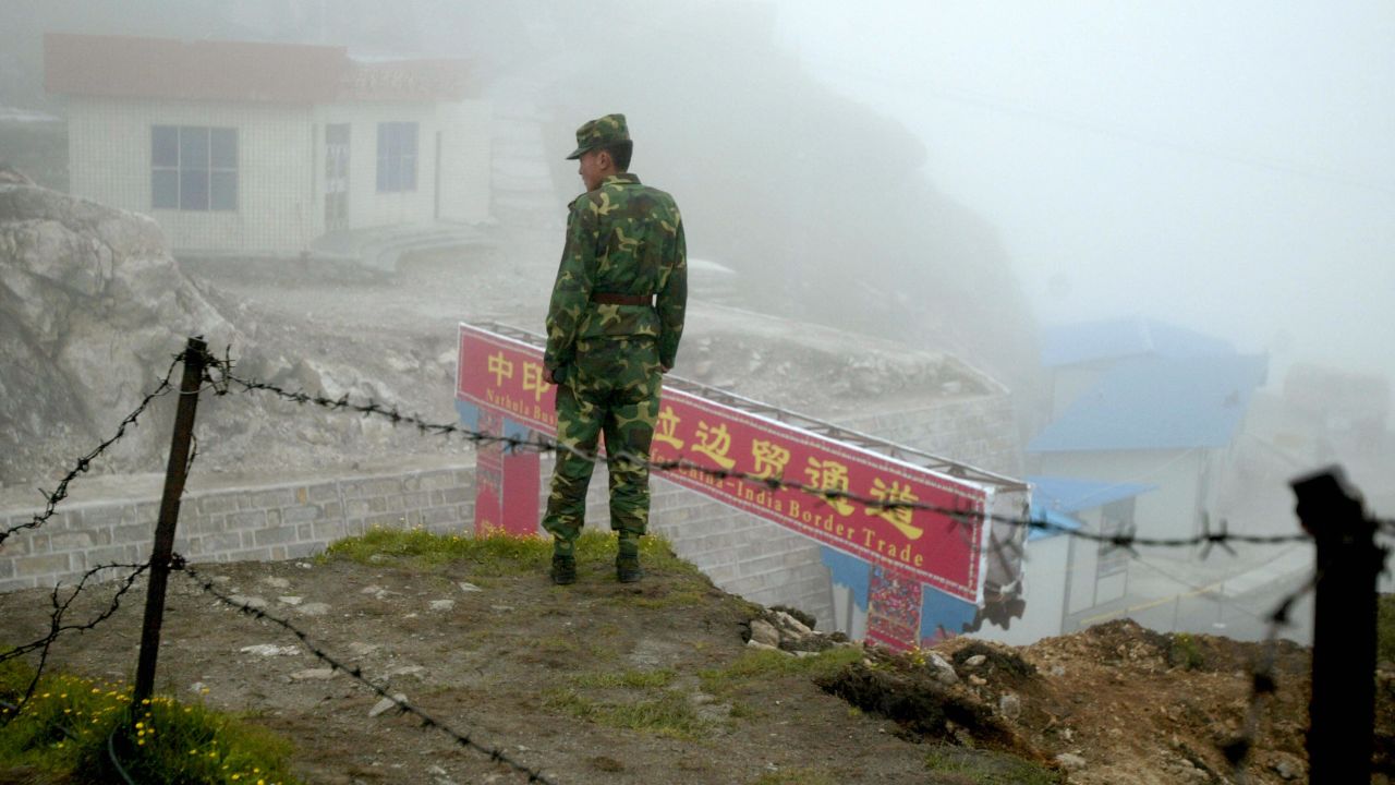 A Chinese soldier stands guard at the ancient Nathu La border crossing between India and China