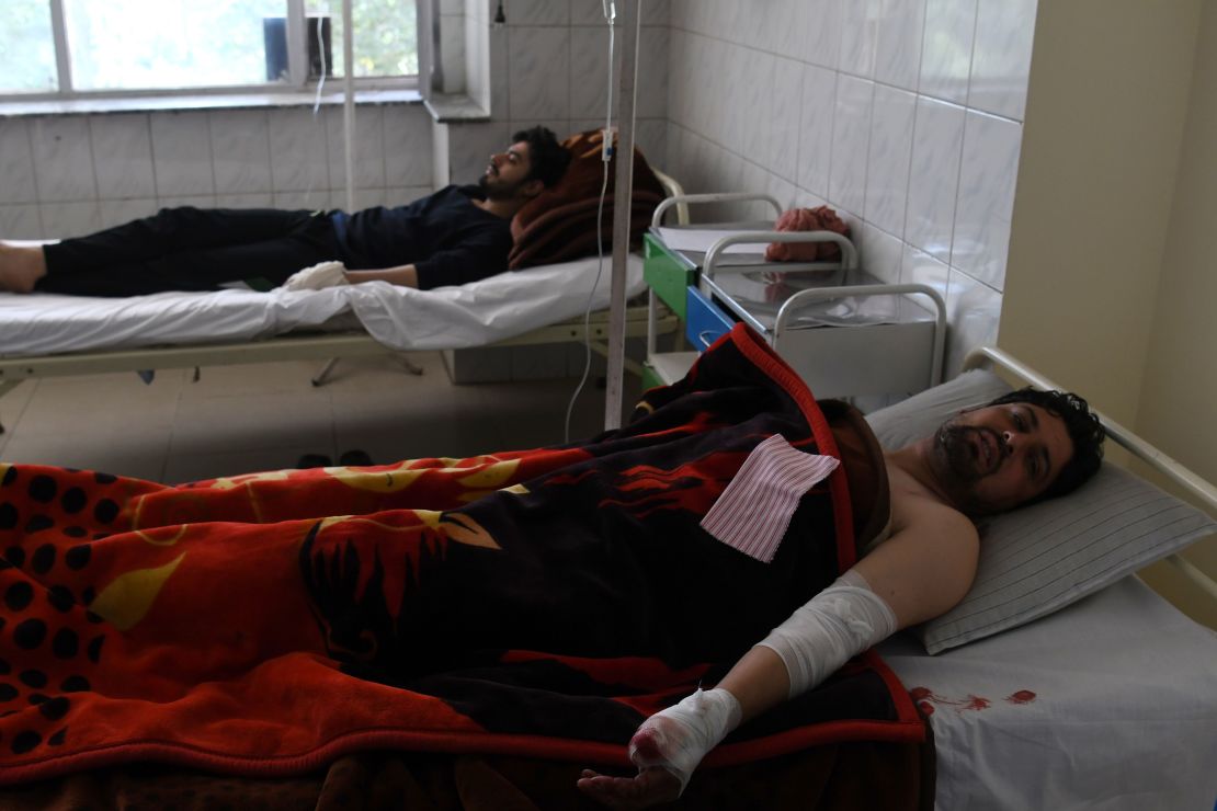 Afghan men rest in hospital after being injured in the attack.