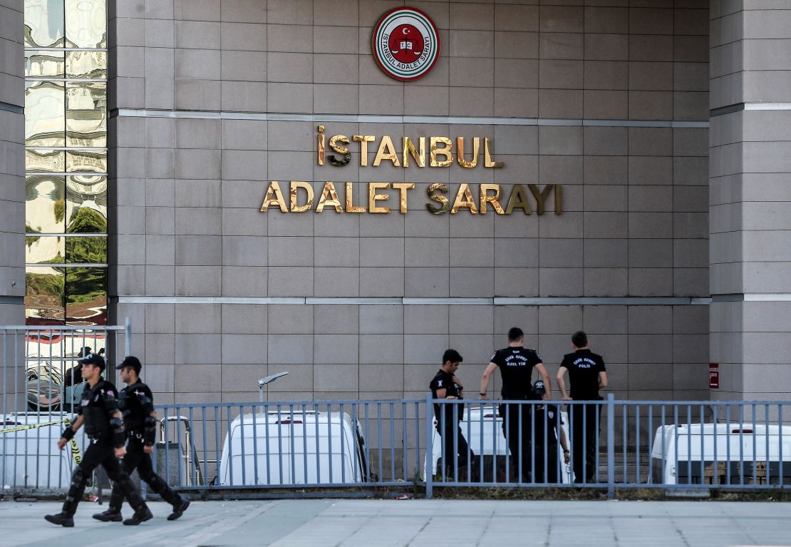 Turkish police stand guard outside the courthouse during the trial