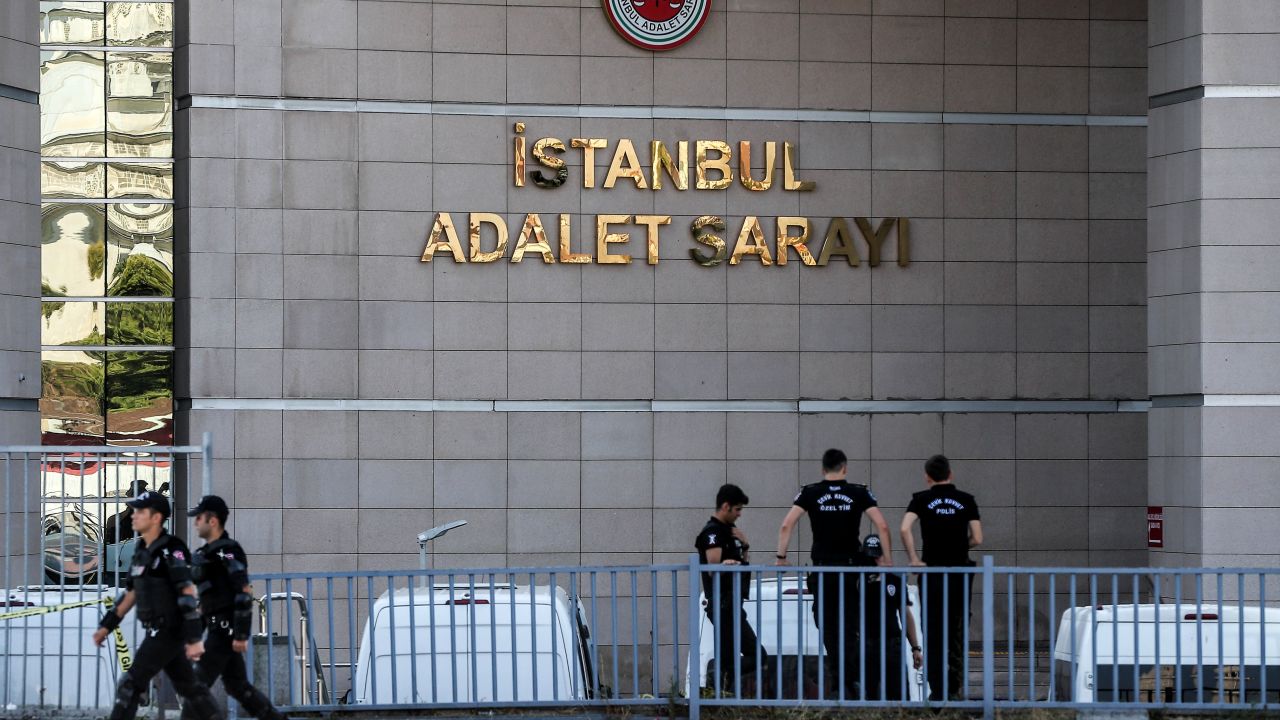 Turkish police stand guard outside the courthouse during the trial 