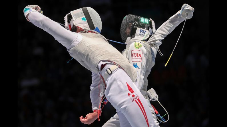 Japan's Toshiya Saito, left, competes against Italy's Daniele Garozzo at the World Fencing Championships on Sunday, July 23. Saito won 15-12 to advance to the final of the men's foil competition.