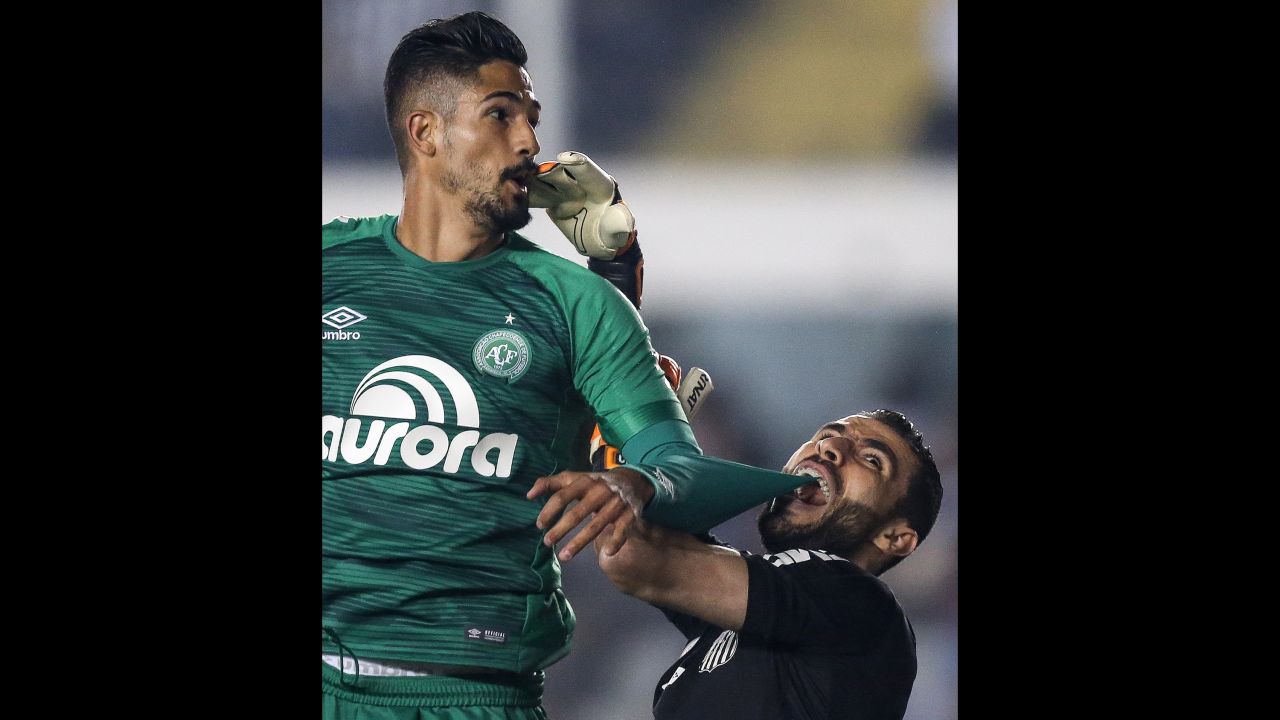 Santos goalkeeper Vanderlei gets Tulio de Melo's shirt stuck in his teeth during a Brazilian league match against Chapecoense on Wednesday, July 19.