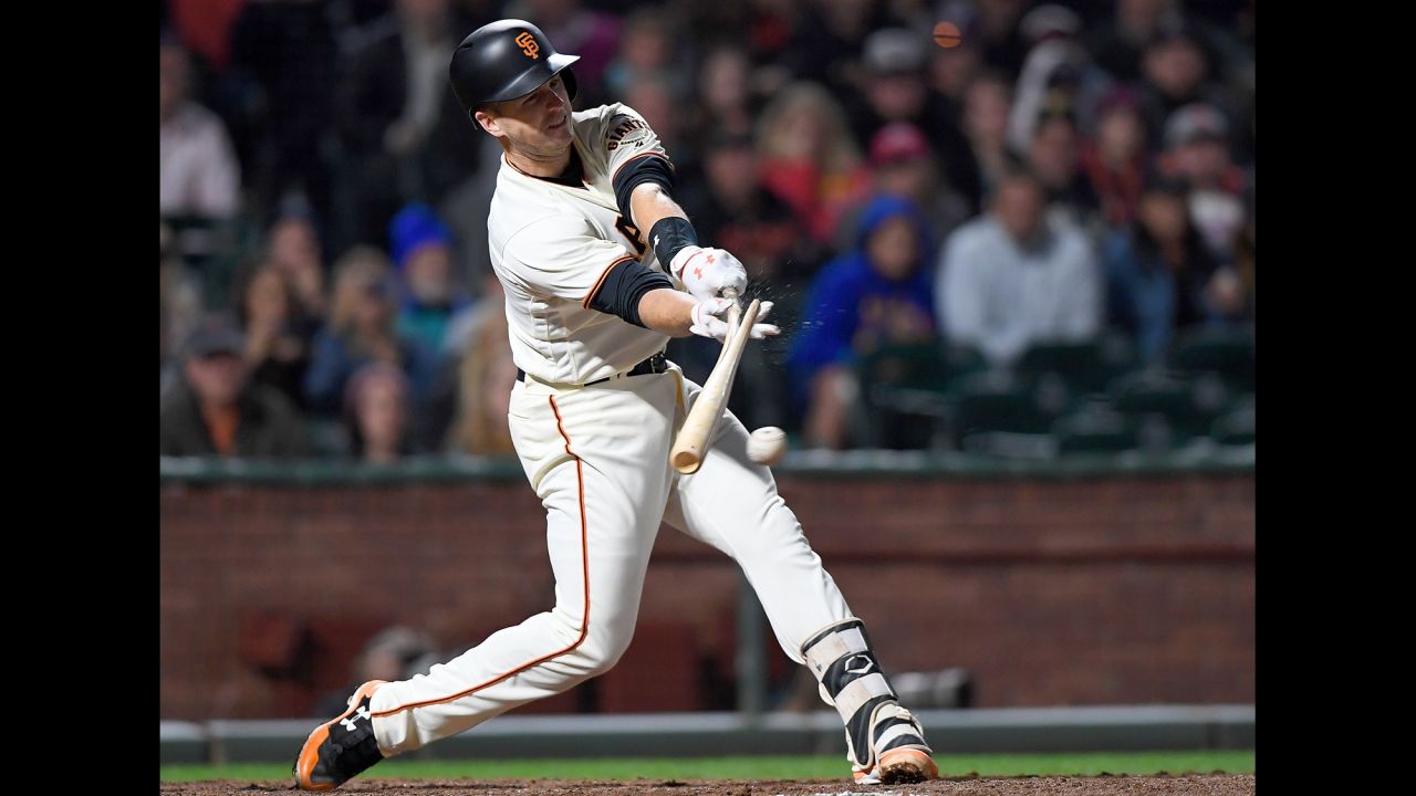 San Francisco star Buster Posey breaks his bat while hitting an RBI single against Cleveland on Thursday, July 18.
