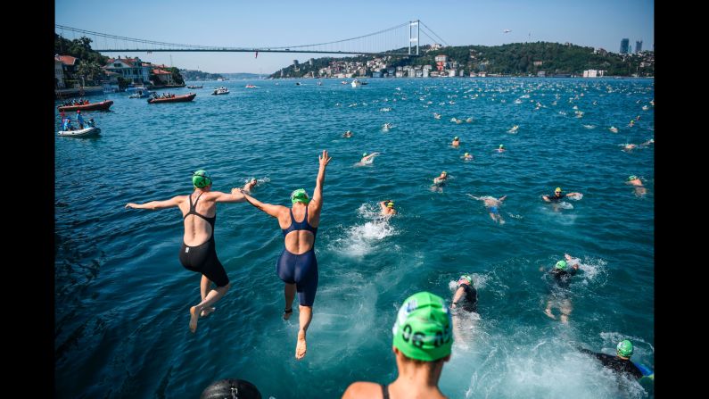Competitors jump in the Bosphorus strait as they take part in the Bosphorus Cross Continental Swim on Sunday, July 23. The swimmers start from the Asian side of Istanbul and race 6.5 kilometers (4 miles) to the European side.