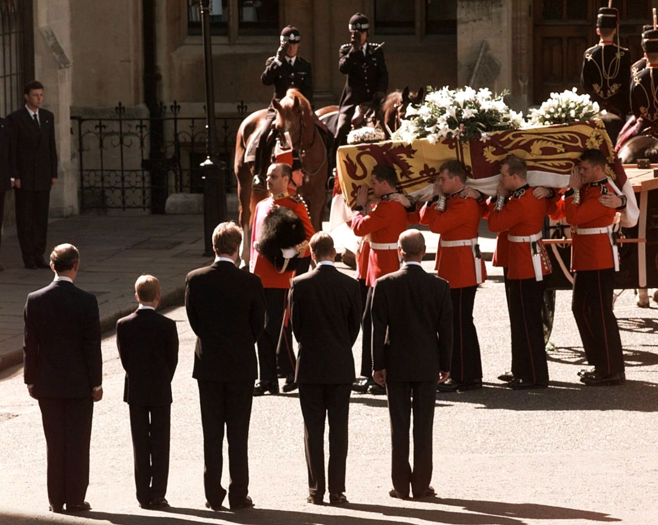 Diana's coffin is carried into London's Westminster Cathedral in September 1997. Watching at the bottom, from left, is Prince Charles, Prince Harry, Charles Spencer, Prince William and Prince Philip.