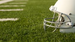 American Football Helmet on the Field with room for copy; Shutterstock ID 152570240
