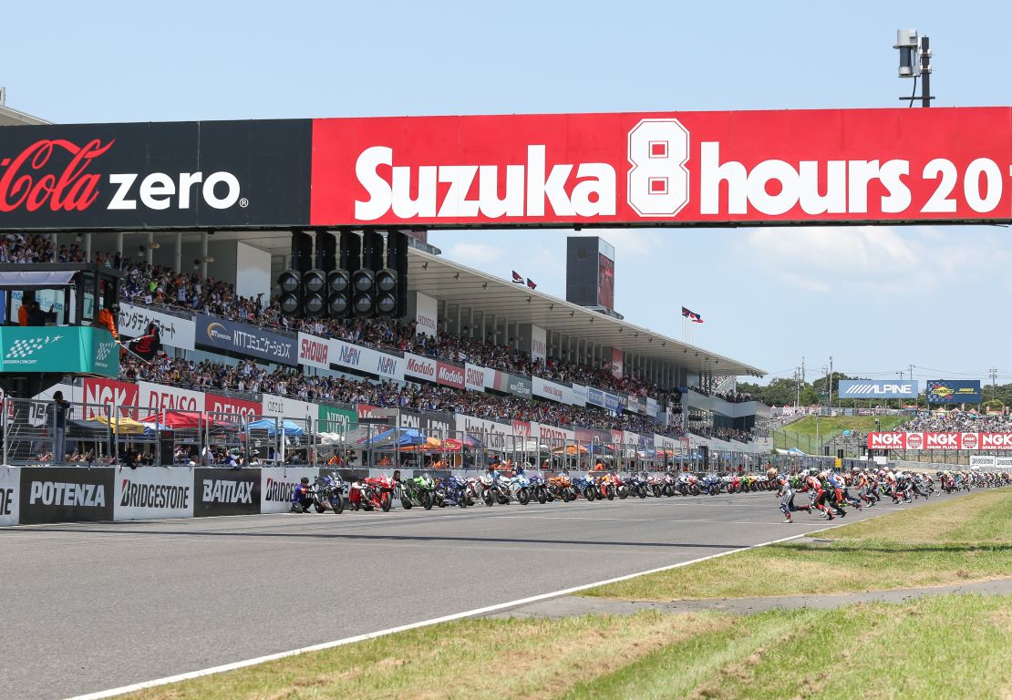 Riders rush towards thier motorbikes at the start of the 2016 Suzuka 8 Hours race.