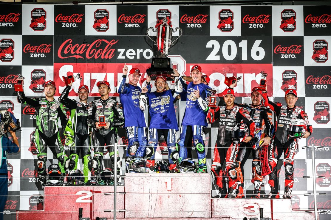 The victorious Yamaha team celebrate on top of the podium at the 2016 race.
