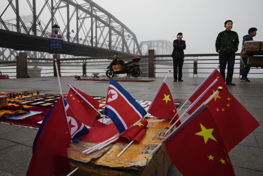 Chinese vendors sell North Korea and China flags on the boardwalk next to the Yalu river in the border city of Dandong in China's Liaoning province.