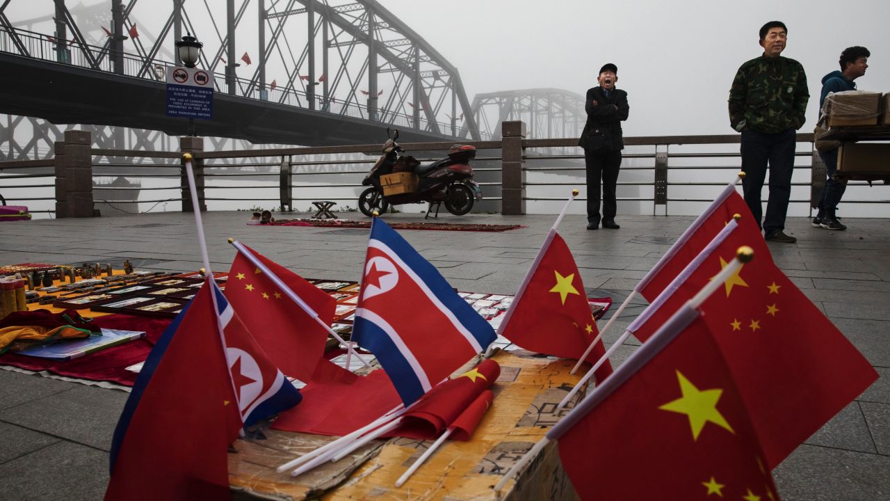 Chinese vendors sell North Korea and China flags on the boardwalk next to the Yalu river in the border city of Dandong in China's Liaoning province.