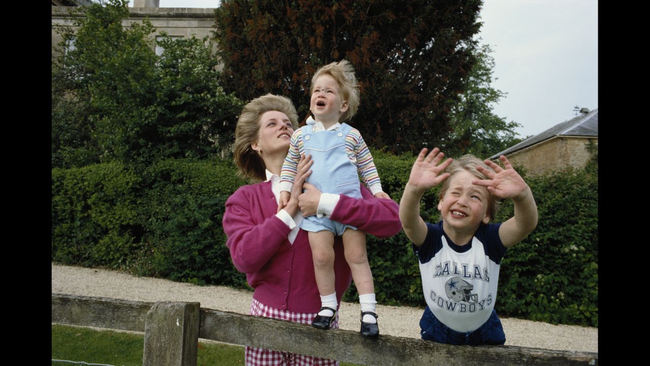 Diana holds up Harry in the garden of Highgrove House, a royal residence in Gloucestershire, England, in July 1986.