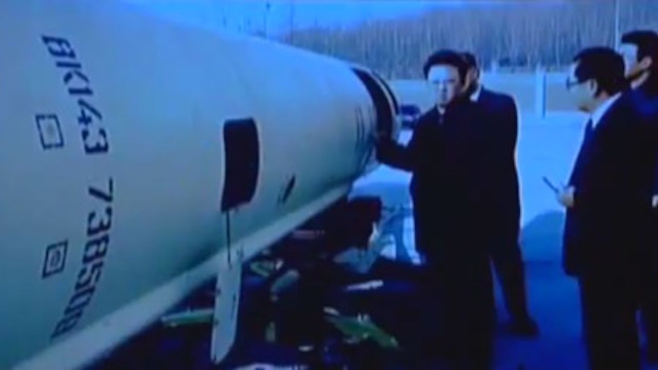 Former North Korean leader Kim Jong Il stands near what appears to be a Scud-B  missile.