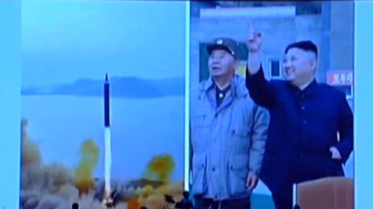 Kim Jong Un watches a test of an intermediate-range ballistic missile, the Hwasong-12.