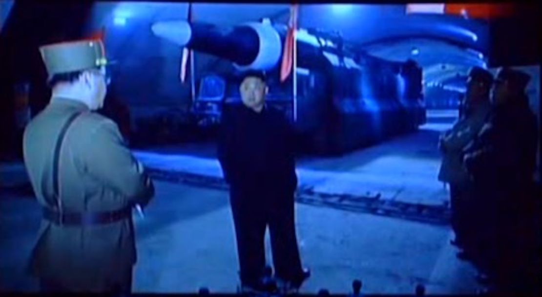 Kim Jong Un standing in front of the Hwasong-12.
