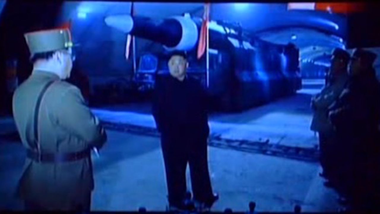 Kim Jong Un standing in front of the Hwasong-12.