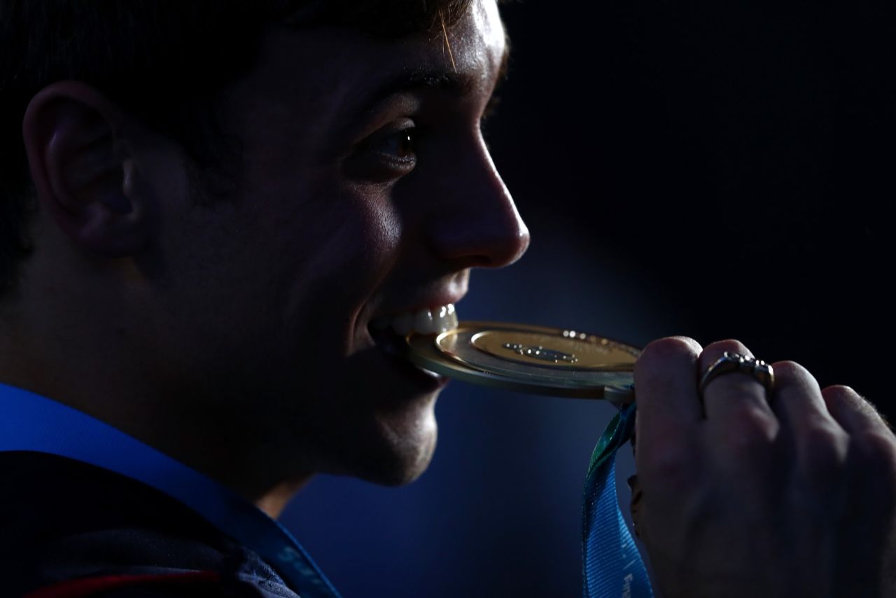 Tom Daley of Great Britain celebrates his gold medal in the men's 10M platform Saturday.