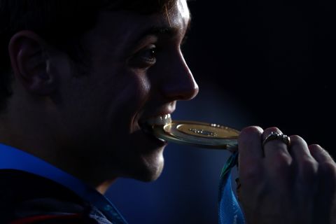 Tom Daley of Great Britain celebrates his gold medal in the men's 10M platform Saturday.