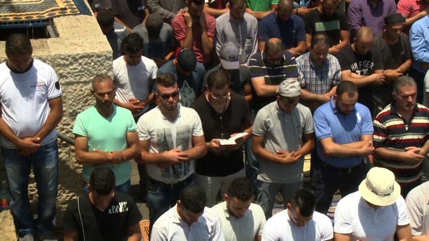 Jerusalem Christian man praying alongside Muslims