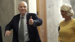 Sen. John McCain (L) (R-AZ) returns to the U.S. Senate accompanied by his wife Cindy (R) July 25, 2017 in Washington, DC. McCain was recently diagnosed with brain cancer but returned on the day the Senate is holding a key procedural vote on U.S. President Donald TrumpÕs effort to repeal and replace the Affordable Care Act.
