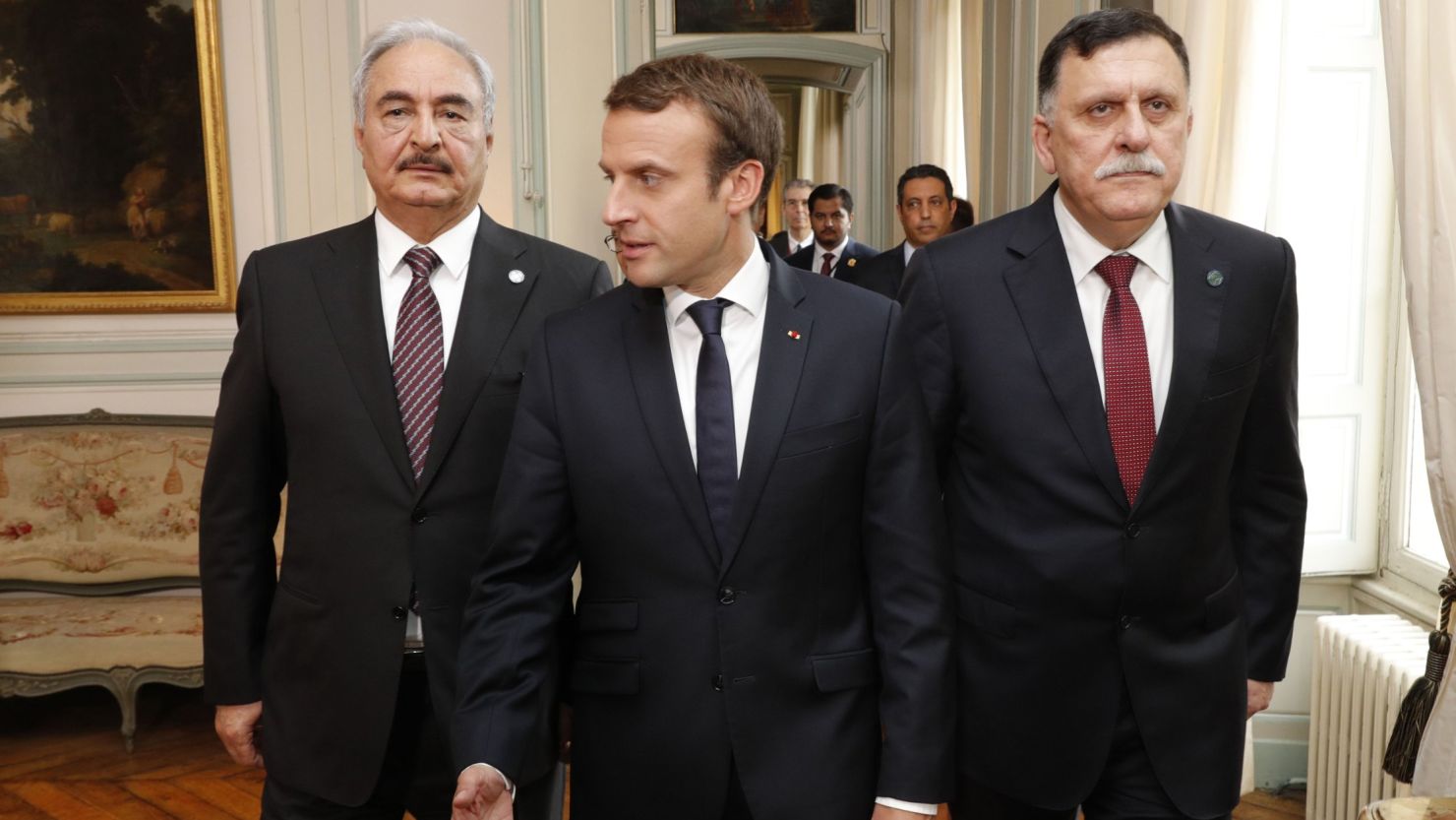 French President Emmanuel Macron is flanked Tuesday in Paris by Libyan Prime Minister Fayez al-Sarraj, left, and Gen. Khalifa Haftar.