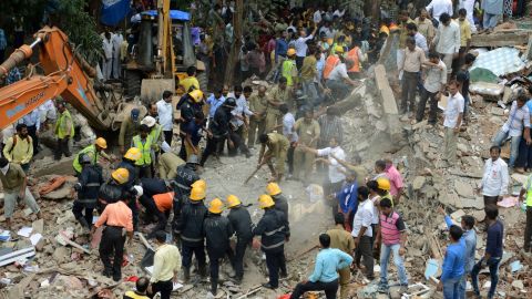 Rescue workers look for survivors in debris at the site of a building collapse in Mumbai on Tuesday.
