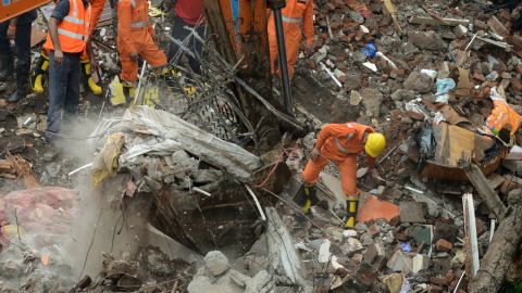 Rescue workers and fire officials look for survivors.