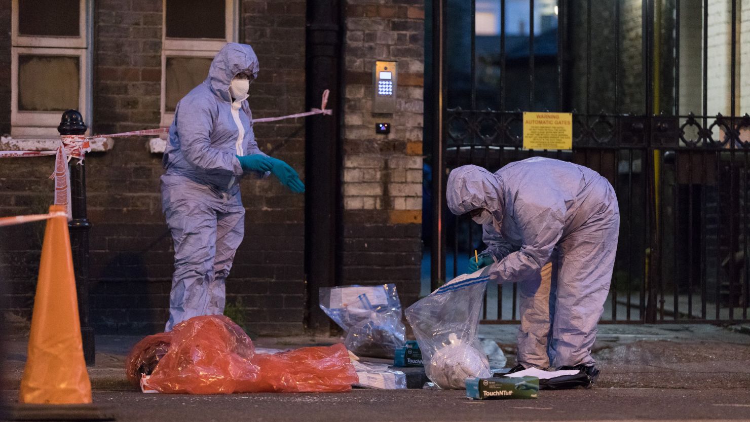 Forensic officers investigate a possible acid attack in east London Tuesday night.