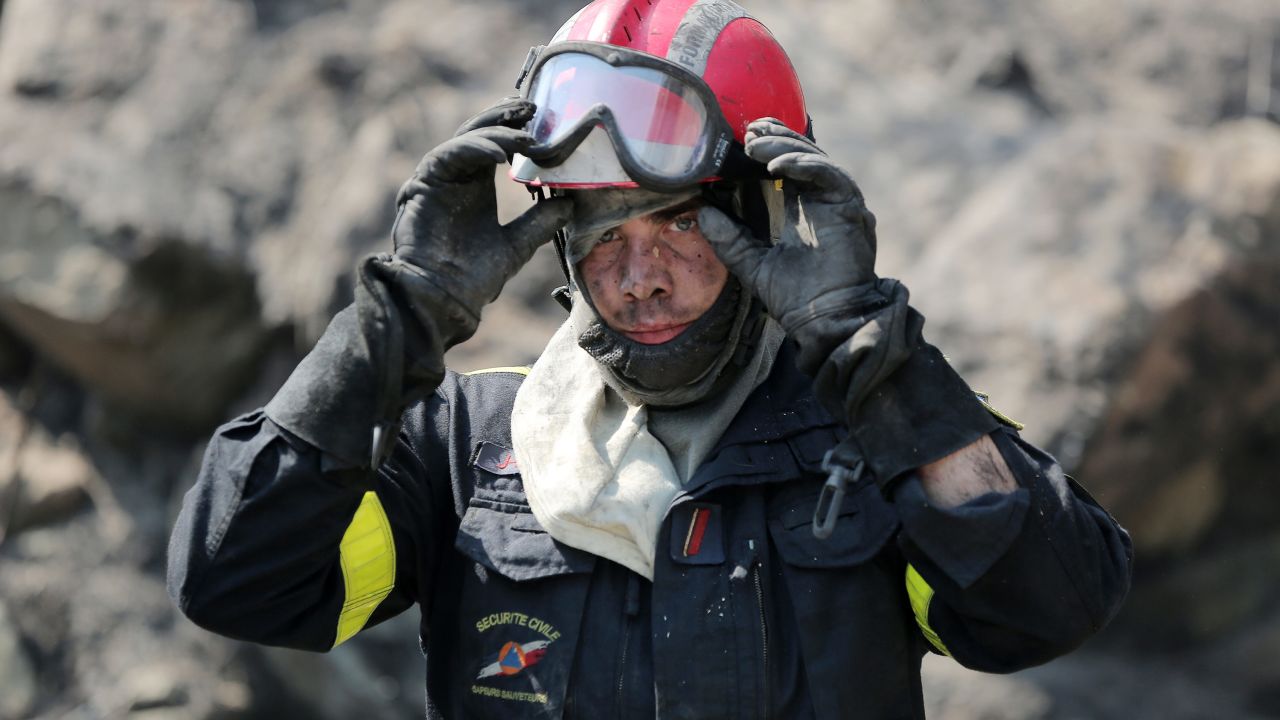 A firefighter takes a break at the site of a wildfire near Ortale, France, on July 25.