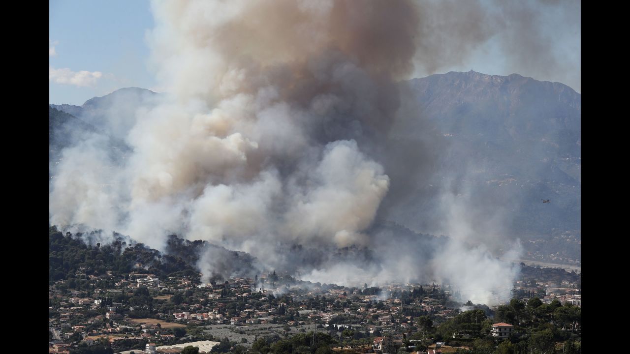 Smoke rises over the town of Carros, France, on Monday, July 24.