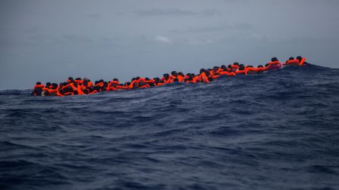 Migrants from sub-Saharan Africa wait for a rescue boat after at least 13 migrants died during the journey in July. 