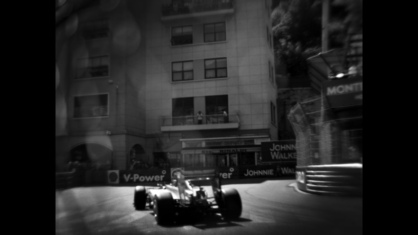 As Formula One cars fly past at speeds of up to 200mph, one man captures them with a camera built in 1913.