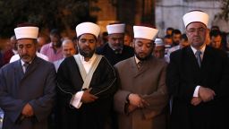 Sheikh Omar Kiswani (2-L), Al-Aqsa director, and other clergymen join as Palestinian Muslim worshippers pray outside Jerusalem's Old City on July 25, 2017 as Muslim officials said worshippers should continue to boycott the Al-Aqsa mosque compound, even after Israel removed newly installed security measures that had triggered deadly violence.
Israel removed metal detectors from a highly sensitive Jerusalem holy site after their installation triggered deadly violence, but Muslim officials said worshippers should continue a boycott for now. Israel installed metal detectors at entrances to the compound after an attack nearby that killed two policemen on July 14. / AFP PHOTO / Ahmad GHARABLI        (Photo credit should read AHMAD GHARABLI/AFP/Getty Images)