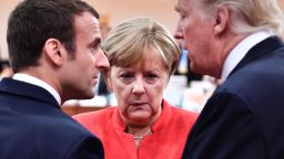 TOPSHOT - (L-R) French President Emmanuel Macron, German Chancellor Angela Merkel and US President Donald Trump confer at the start of the first working session of the G20 meeting in Hamburg, northern Germany, on July 7.
Leaders of the world's top economies will gather from July 7 to 8, 2017 in Germany for likely the stormiest G20 summit in years, with disagreements ranging from wars to climate change and global trade. / AFP PHOTO / AFP PHOTO AND POOL / John MACDOUGALL        (Photo credit should read JOHN MACDOUGALL/AFP/Getty Images)