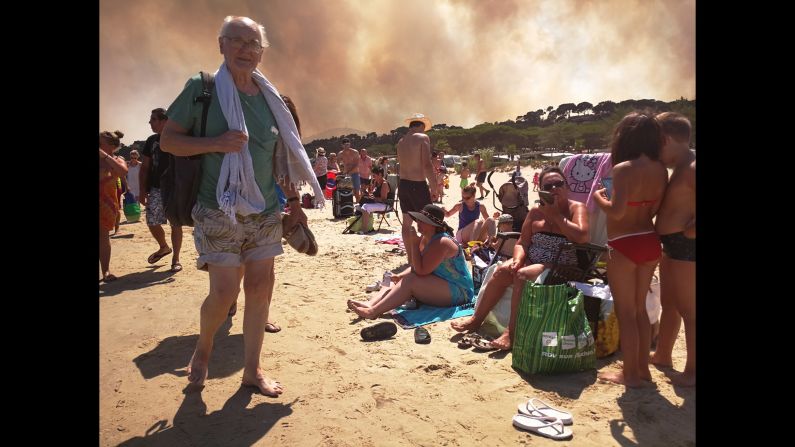 Tourists gather after a campsite was evacuated because of raging wildfires near Bormes-les-Mimosas, France, on Wednesday, July 26. Parts of the French Riviera <a href="index.php?page=&url=http%3A%2F%2Fwww.cnn.com%2F2017%2F07%2F26%2Feurope%2Ffrance-wildfire-evacuations%2Findex.html" target="_blank">were evacuated late Tuesday and into Wednesday </a>as forest fires burned swaths of land and threatened thousands of people.