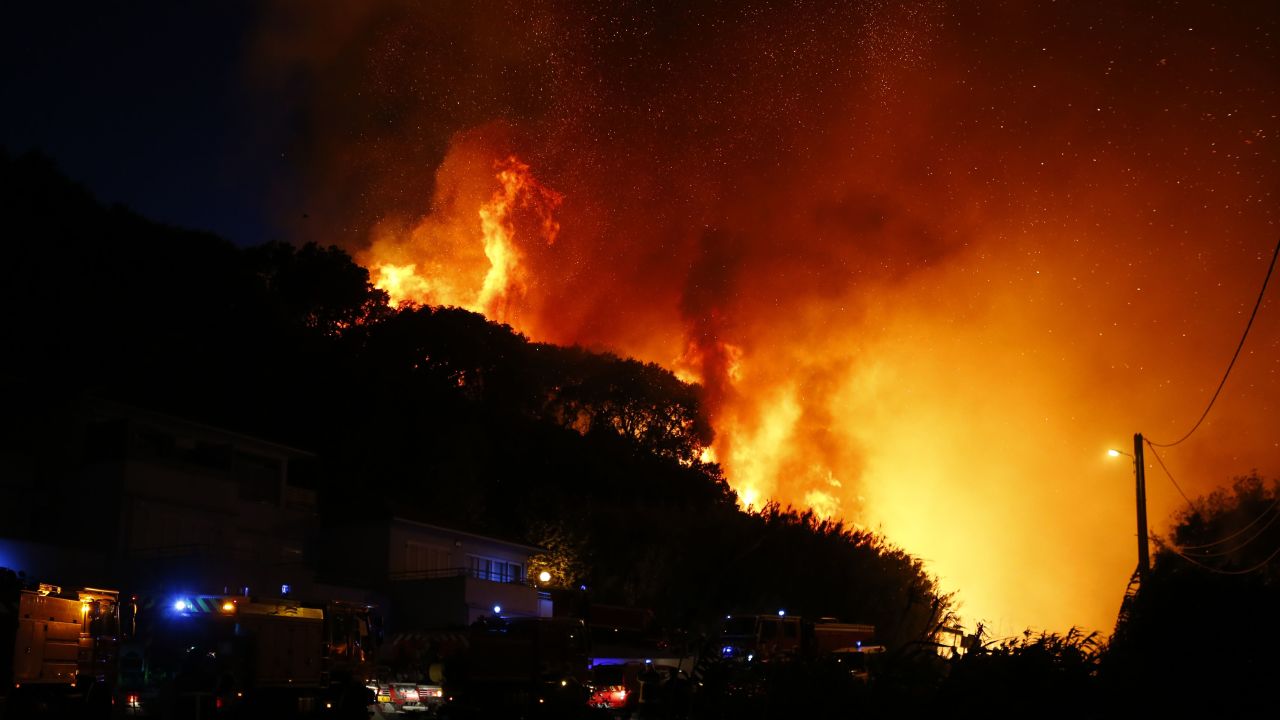 Firefighters gather at the site of a fire in Biguglia, on the French Mediterranean island of Corsica, on July 24, 2017.
Dozens of firefighters were battling a blaze on the French island of Corsica on July 24 that has spread across 900 hectares of forest and was threatening homes, emergency services said. Residents were evacuated from homes at the edge of the town of Biguglia, on the island's northeastern coast.
 / AFP PHOTO / PASCAL POCHARD-CASABIANCA        (Photo credit should read PASCAL POCHARD-CASABIANCA/AFP/Getty Images)