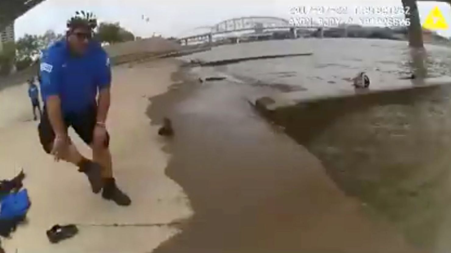 Footage from an officer's body camera shows this officer preparing to jump in the river.