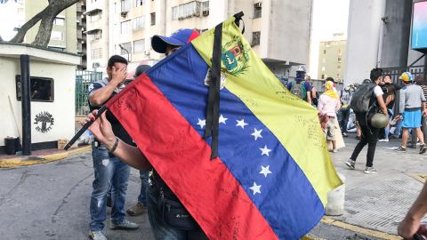 A protester waves the national flag in Caracas on Wednesday.