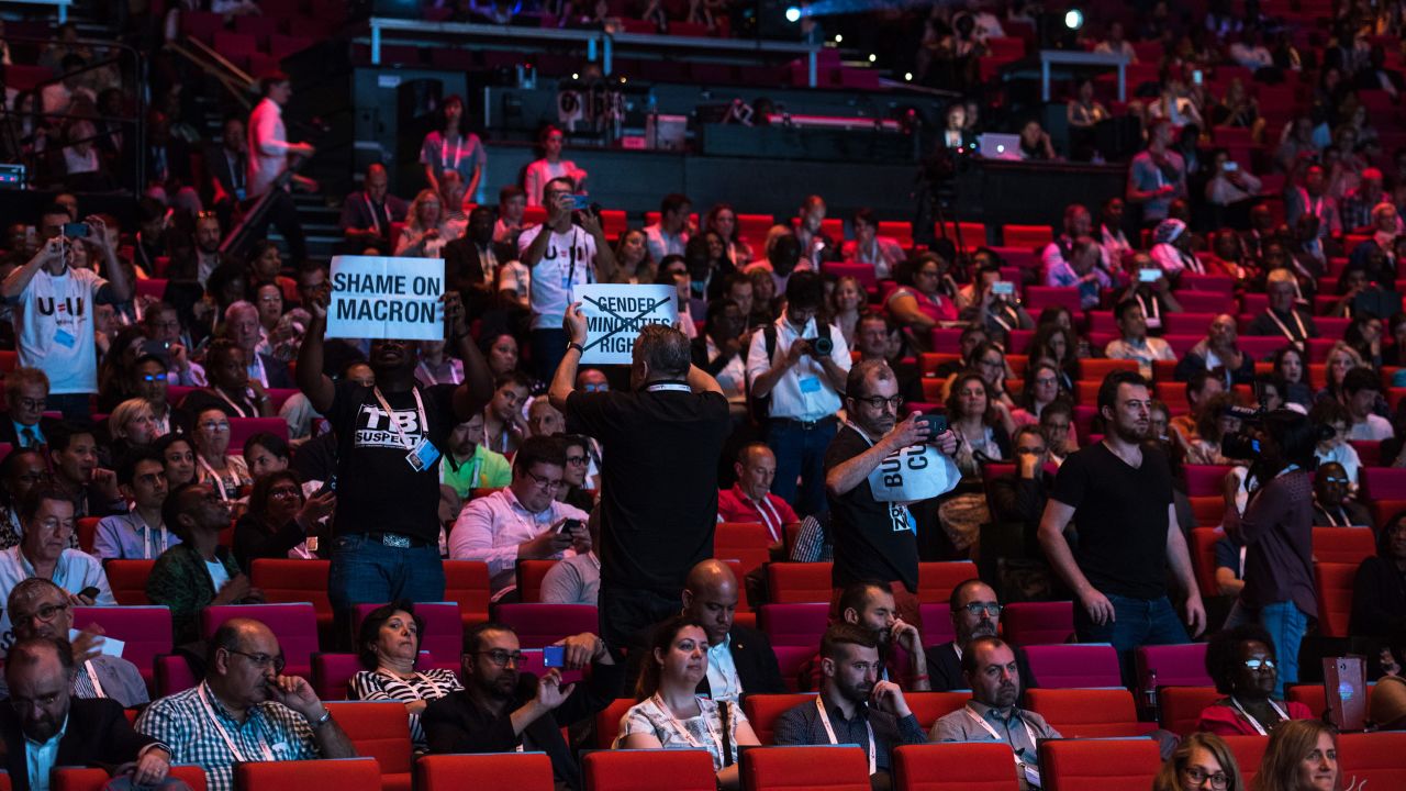 Political activists question French President Emmanuel Macron's failure to open this week's AIDS conference in Paris.