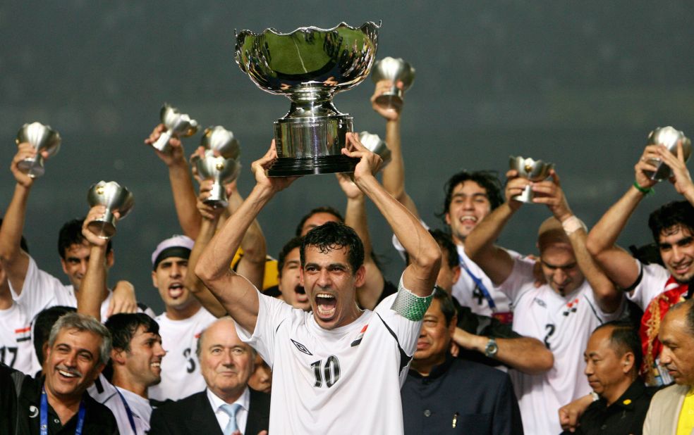 Iraq's captain and goalscorer in the final, Younis Mohmoud, holds the Asian Cup trophy aloft.