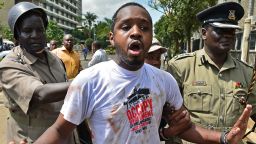 Kenyan activist Boniface Mwangi is arrested during a demonstration against Members of Parliament who have demanded higher wages, outside Pariliament in Nairobi on May 14, 2013. The protestors had intended to occupy parliament but were dispersed, beaten by police and arrested. Keny'a lawmakers receive a tax-free salary of around 10,000 USD  (about 7,700 euros) per month. AFP PHOTO/Carl de Souza        (Photo credit should read CARL DE SOUZA/AFP/Getty Images)