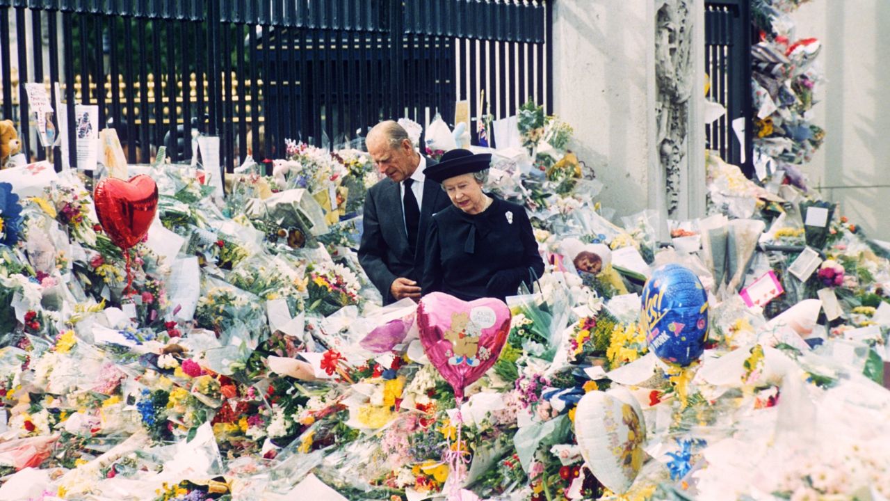 On the eve of Diana's funeral, the Queen and Prince Philip look at floral tributes left outside Buckingham Palace. More than 1 million bouquets of flowers were left at Kensington Palace, Buckingham Palace and St. James's Palace in the wake of Diana's death.