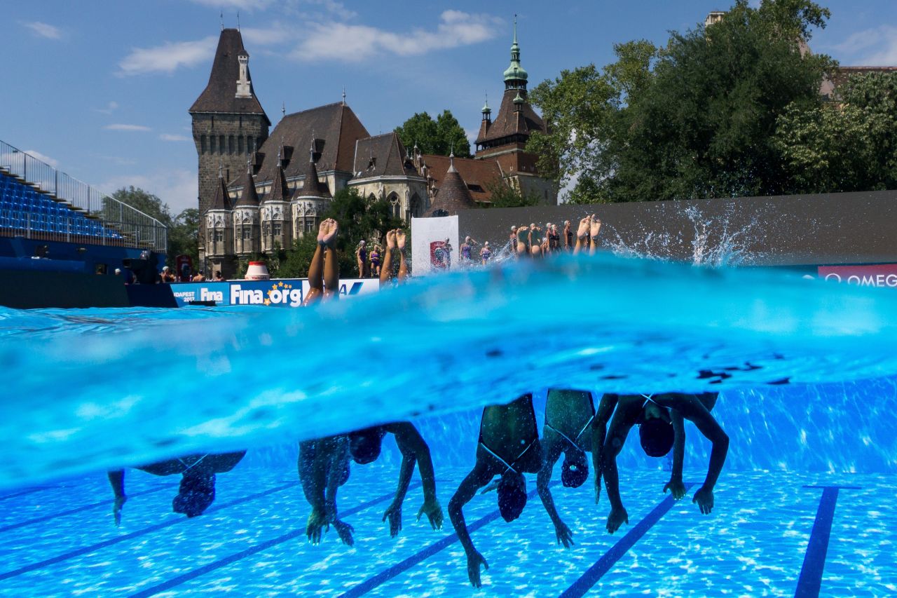 Half in, half out ... swimmers practice in the synchronized swimming free routine competition.