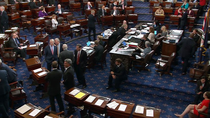 Senators talk on the floor of the US Senate before the vote on the "skinny repeal" on July 28.