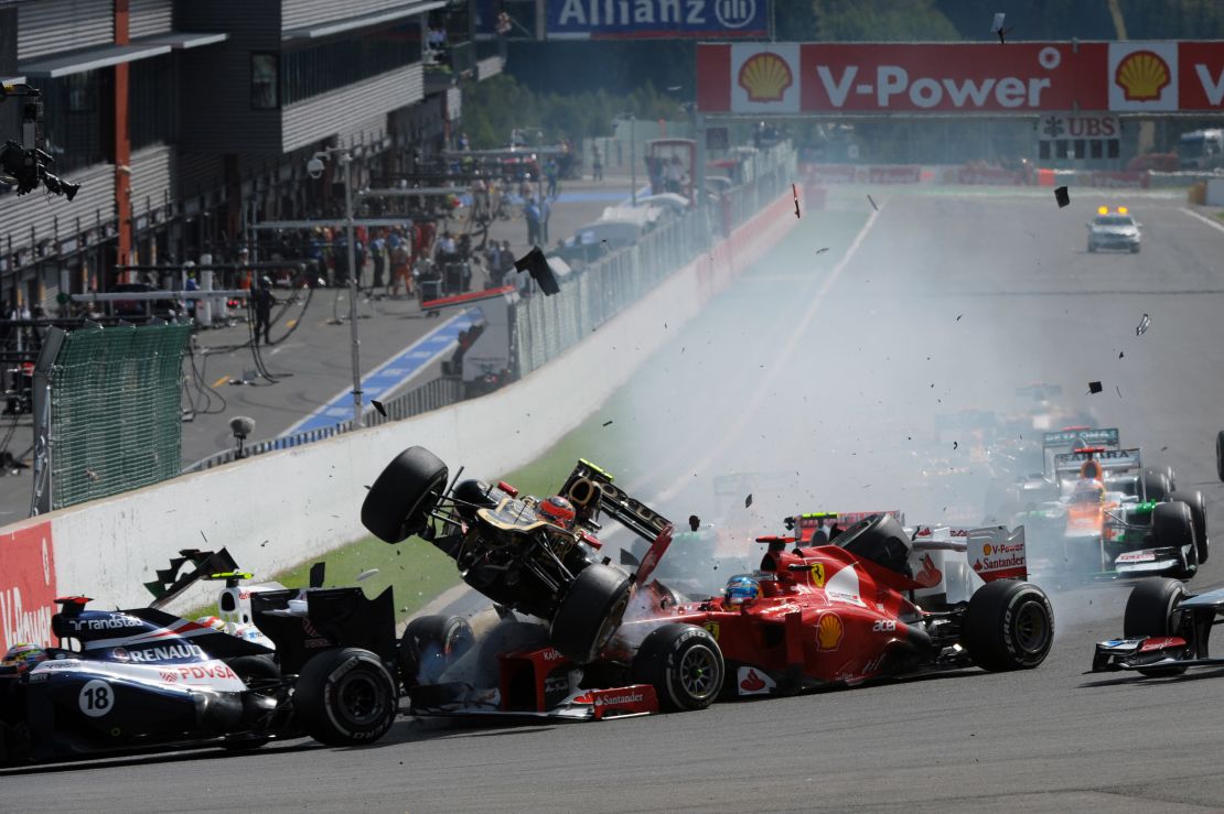 Romain Grosjean's Lotus car narrowly avoids Fernando Alonso at the 2012 Belgium Grand Prix.