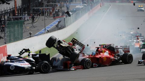 Romain Grosjean's Lotus car narrowly avoids Fernando Alonso at the 2012 Belgium Grand Prix. 