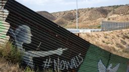 Partial view of the US-Mexico border wall painted by members of the Brotherhood Mural organization in Tijuana, Mexico on July 6, 2017. 
US President Donald Trump said on July 7, 2017, he still wants Mexico to pay for a planned border wall, as he met his Mexican counterpart Enrique Pena Nieto on the sidelines of the G20 summit in Hamburg, Germany, for the first time as head of state. / AFP PHOTO / GUILLERMO ARIAS        (Photo credit should read GUILLERMO ARIAS/AFP/Getty Images)