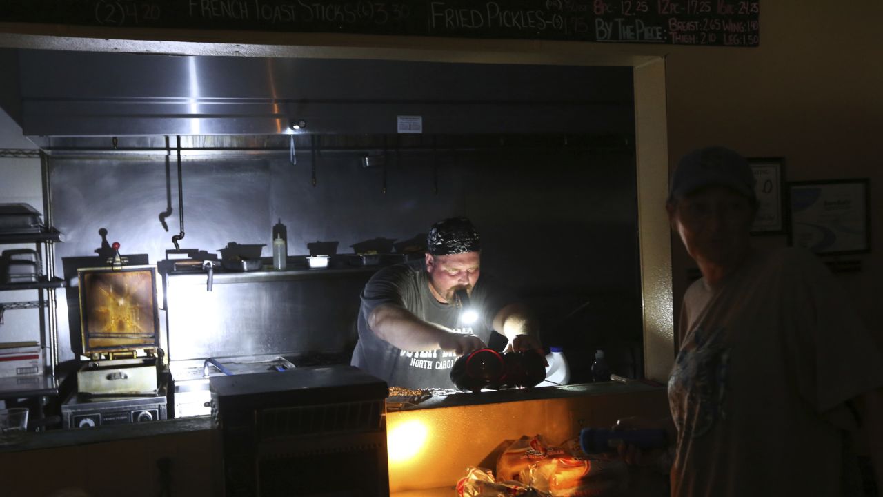 Aaron Howe cooks in a dark kitchen Friday on Hatteras Island.