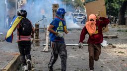 Masked opposition demonstrators take part in clashes with riot police ensuing an anti-government protest in Caracas, on July 26, 2017.
Venezuelans blocked off deserted streets Wednesday as a 48-hour opposition-led general strike aimed at thwarting embattled President Nicolas Maduro's controversial plans to rewrite the country's constitution got underway. / AFP PHOTO / FEDERICO PARRA        (Photo credit should read FEDERICO PARRA/AFP/Getty Images)